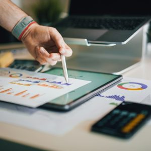 Tablet üzerinde grafikleri inceleyen kişi